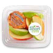 Apple slices with a travel container of peanut butter in a plastic container