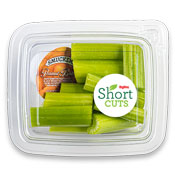 Cut celery sticks in a plastic container with a travel container of peanut butter