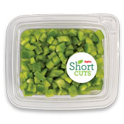 Green peppers that have been diced into small pieces and placed in a plastic container