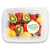 kiwi, strawberries, blueberries, and pineapple in a plastic container