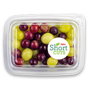 Green and purple grapes in a plastic container