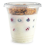 Greek yogurt in a cup with a granola layer at the top and fruit mixed in