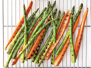 grilled asparagus and carrots sitting on a cooling rack