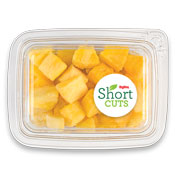 top down view of a plastic container full of pineapple chunks
