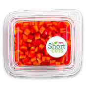 Top down view of a plastic container filled with diced up red peppers