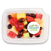 strawberries, red grapes, watermelon, pineapple, honeydew, and cantaloupe in a plastic container