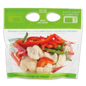 Cut green and red bell peppers with cauliflower in a clear plastic bag