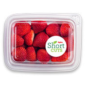 Top down view of full strawberries in a plastic container