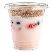 Strawberry yogurt in a cup with a granola topping and fruit mixed in the yogurt