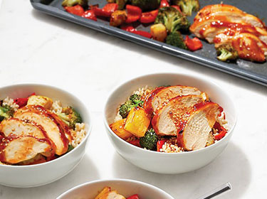 sliced chicken breasts in bowls with rice