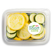 Zucchini and summer squash cut into slices and mixed together in a plastic container